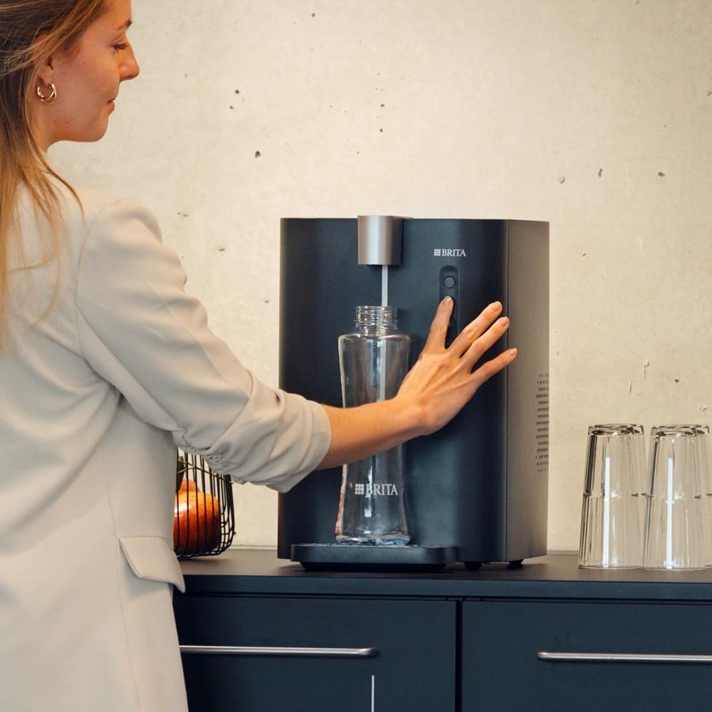 Mains-fed commercial drinking-water dispenser in an office kitchen