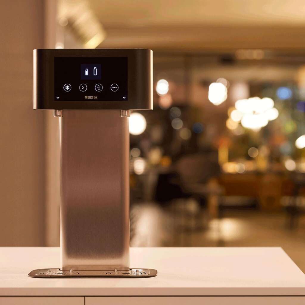 BRITA Fill T-Tap dispenser Saudi Arabia: bartender serving filtered water to guests at a hotel bar