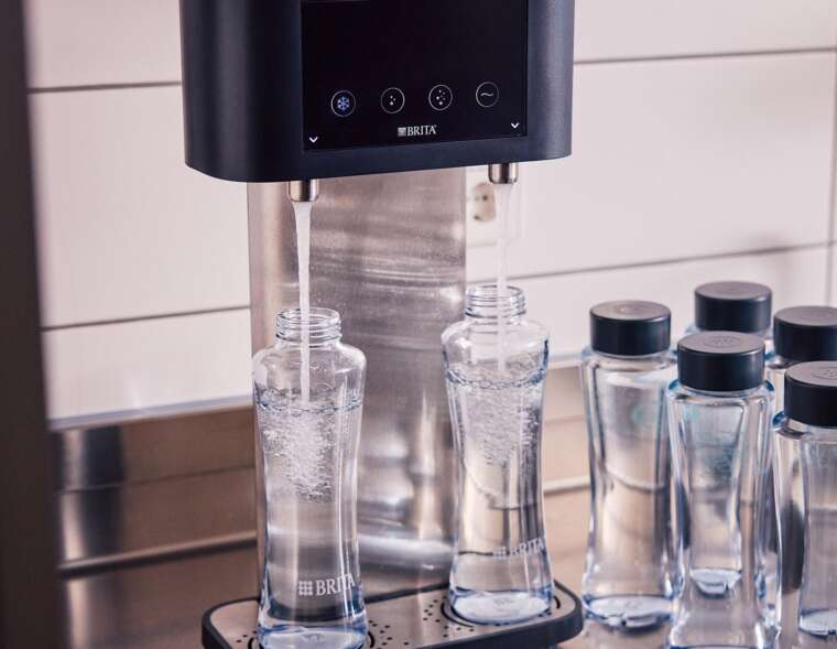 BRITA Fill T-Tap dispenser Saudi Arabia: cafe counter with reusable glass bottles ready for guest service